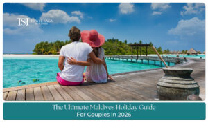 Romantic couple walking along a pristine Maldives beach with turquoise waters and overwater villas.