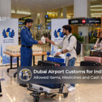 Indian travellers passing through Dubai Airport customs with their luggage and travel documents.